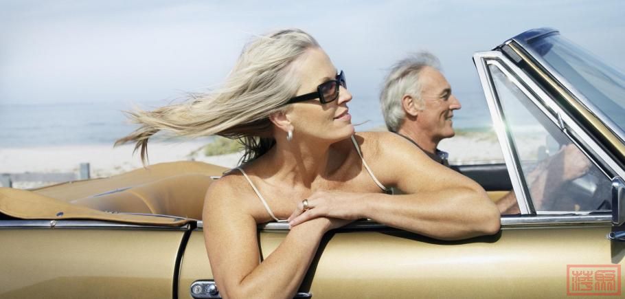 Couple-Riding-in-Convertible-on-Oceanfront-Road.jpg
