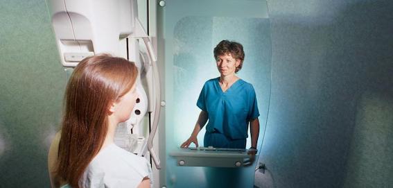 X-ray-technician-giving-woman-mammogram.jpeg