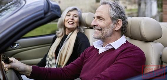 Happy-grey-haired-couple-in-convertible-car.jpeg